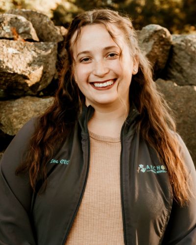 Zoe headshot in front of stone wall